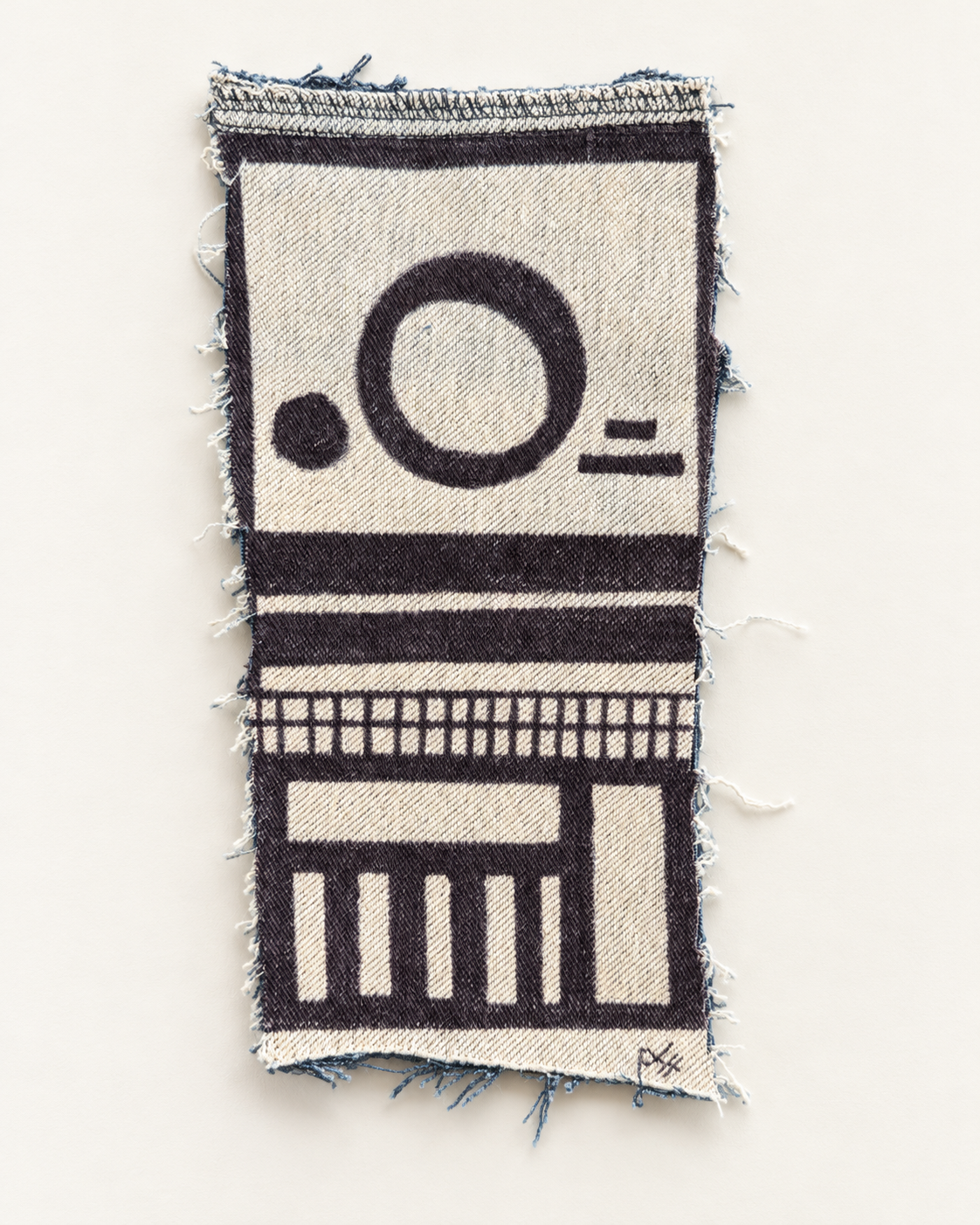 A black circle, horizontal bands and a grid of columns drawn on a tall, frayed denim fragment.
