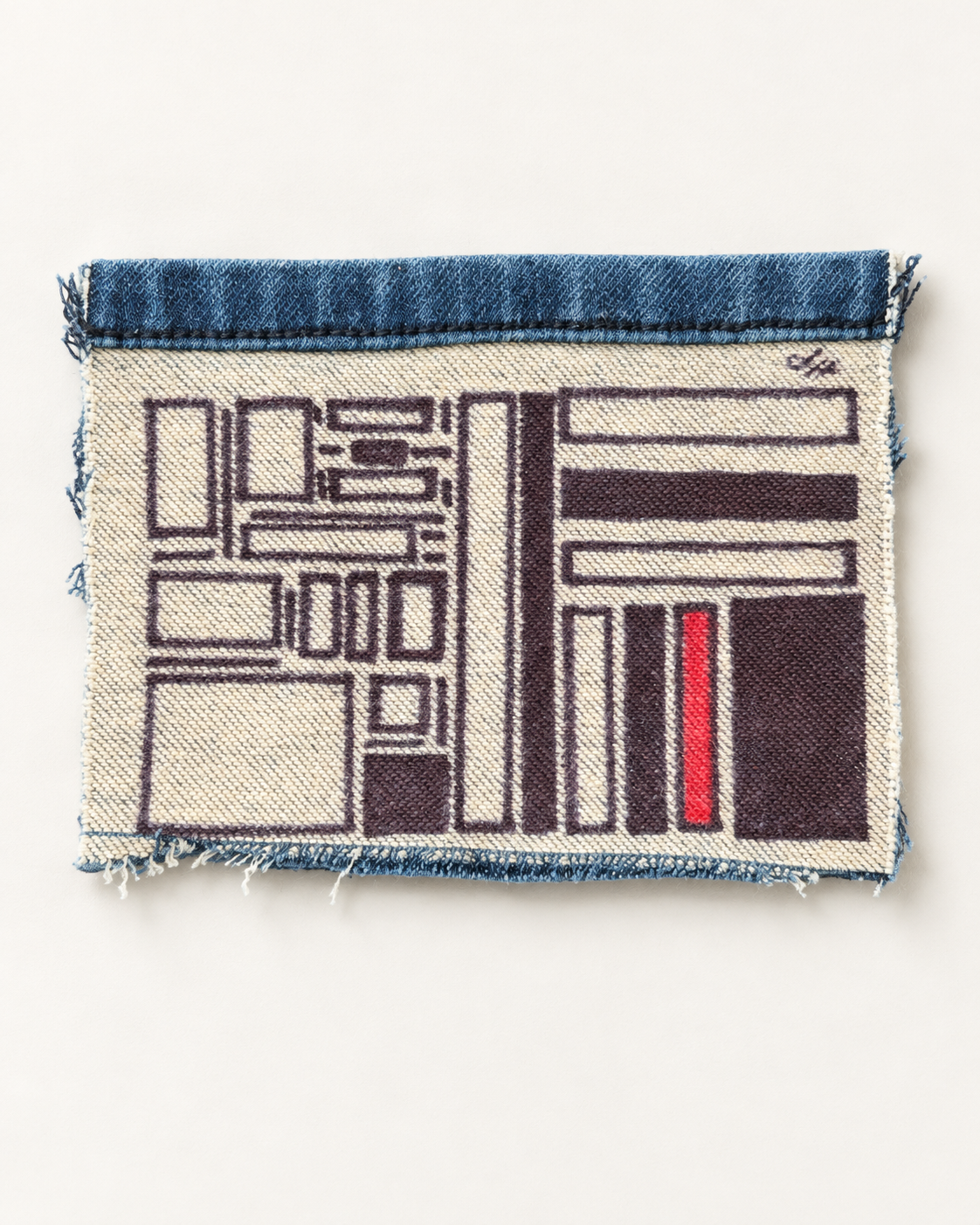 A horizontal arrangement of black blocks and outlined rectangles, punctuated by a red bar and a blue denim seam.
