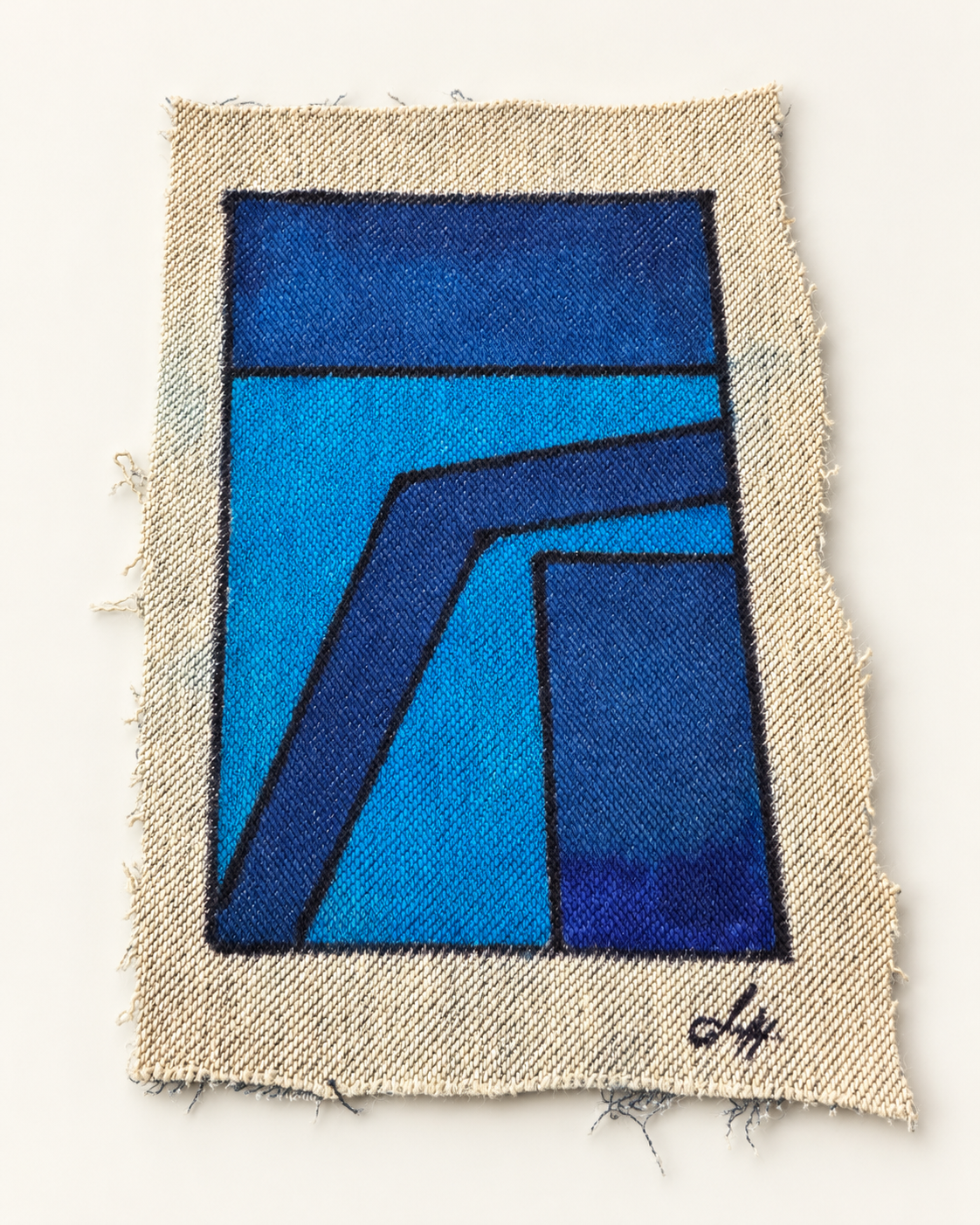Deep blue angular bands cross a bright cyan field on signed, frayed cream denim.